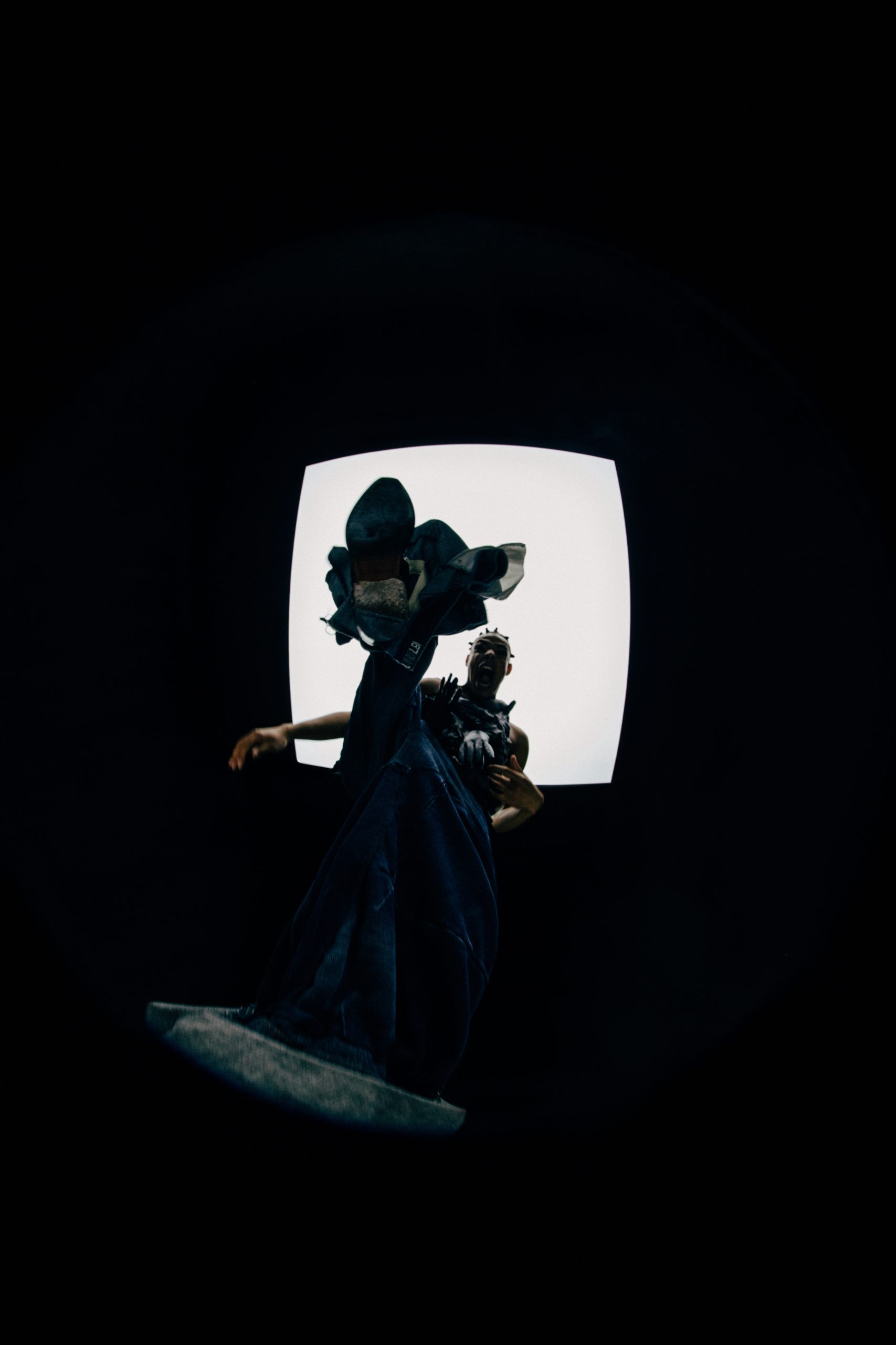 image of black model stomping into the camera shot from below