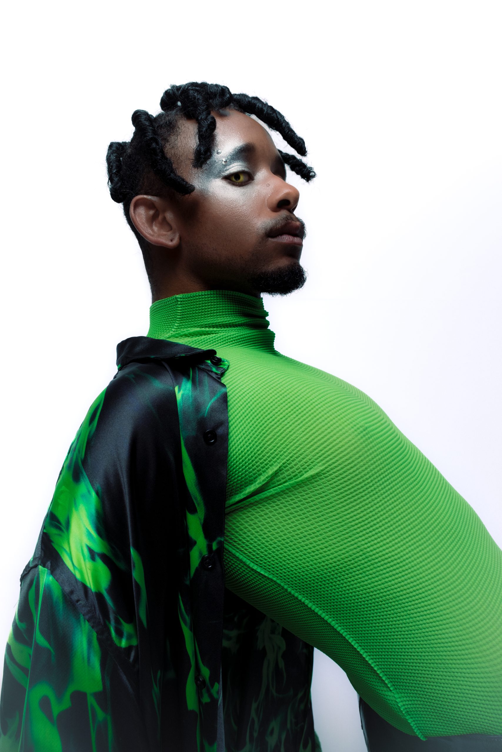 medium image of black model in green turtle neck shot from the side