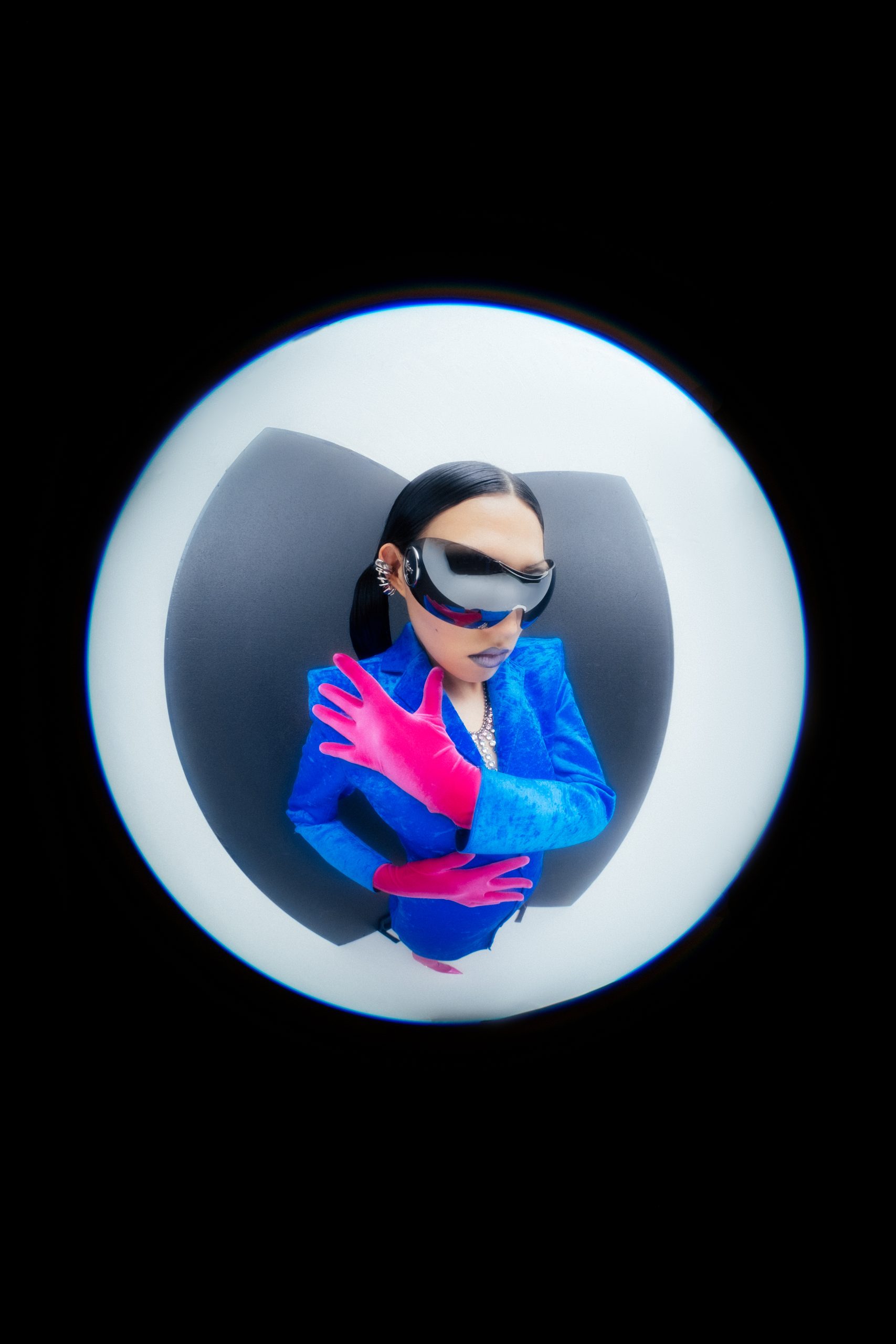 Fisheye closeup shot of asian female model dressed in blue with large sunglasses