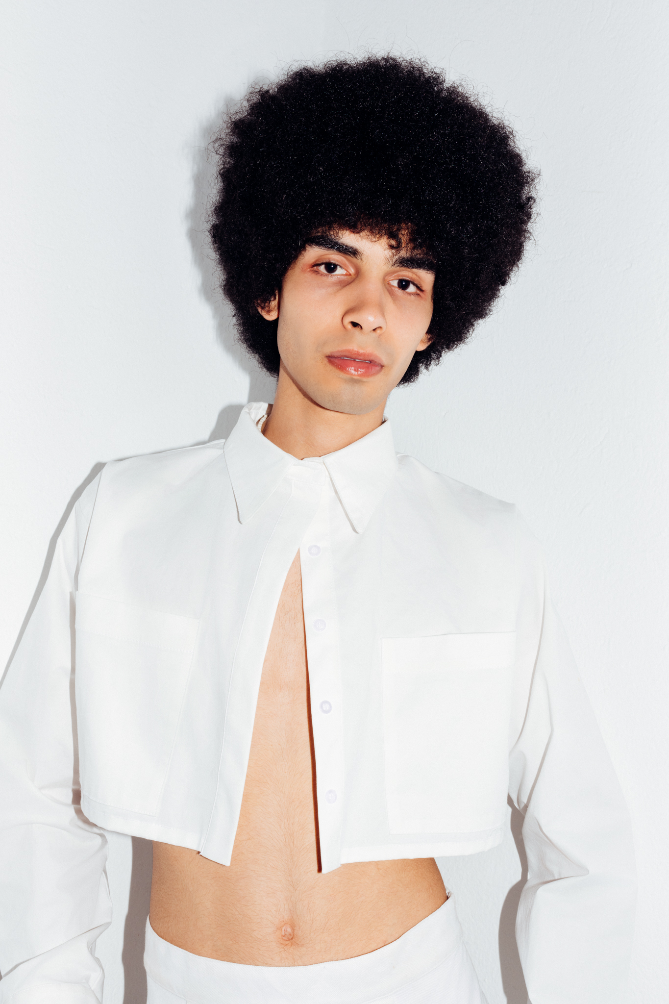 Tunisian male model Yassin Walhezi wears a cropped shirt by Calestis.