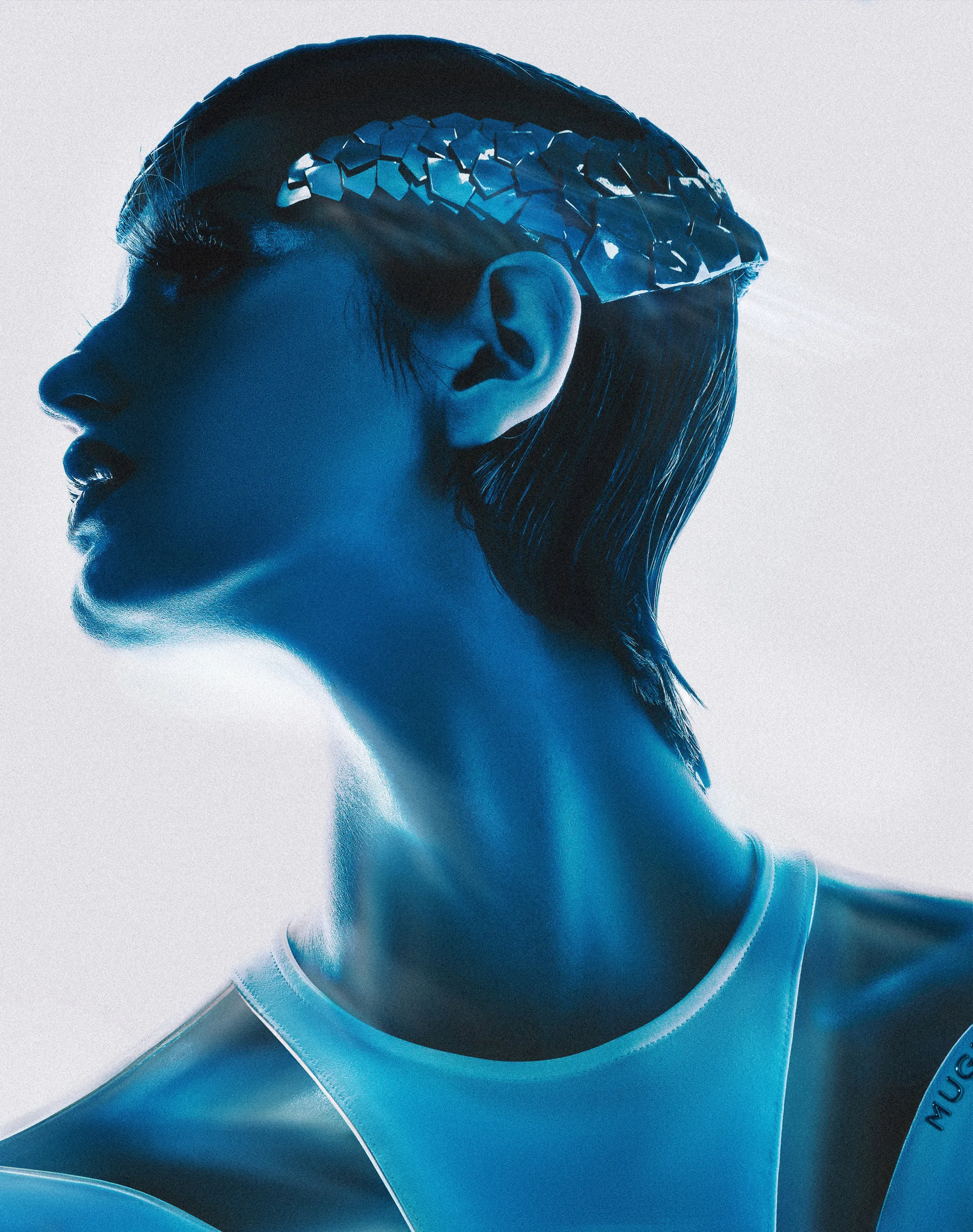 Female Model Natalie Honkonen wearing a helmet / headpiece by Ilariusss and a bodysuit by Mugler. Photographed in blue light by Dan-Cristian Gocan. Taken from the fashion editorial "Queen of Disaster"